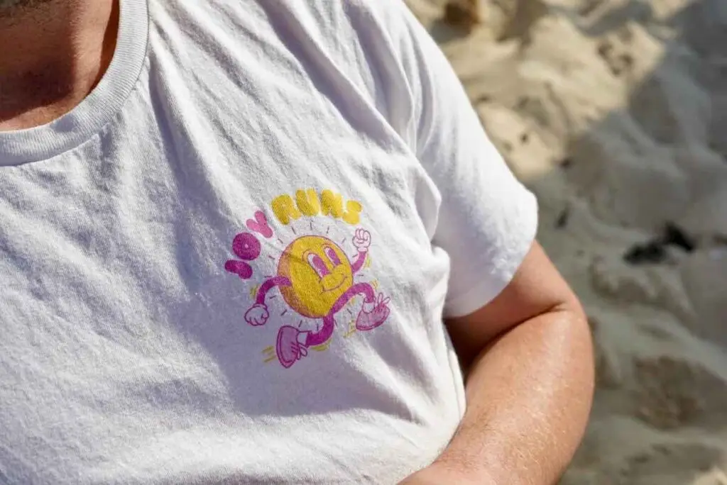 Joy Runs t-shirt on a beach