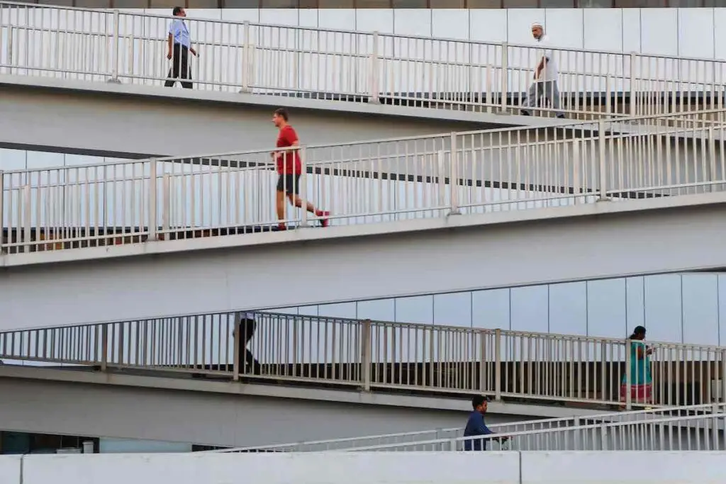 Runner and walkers on a bridge