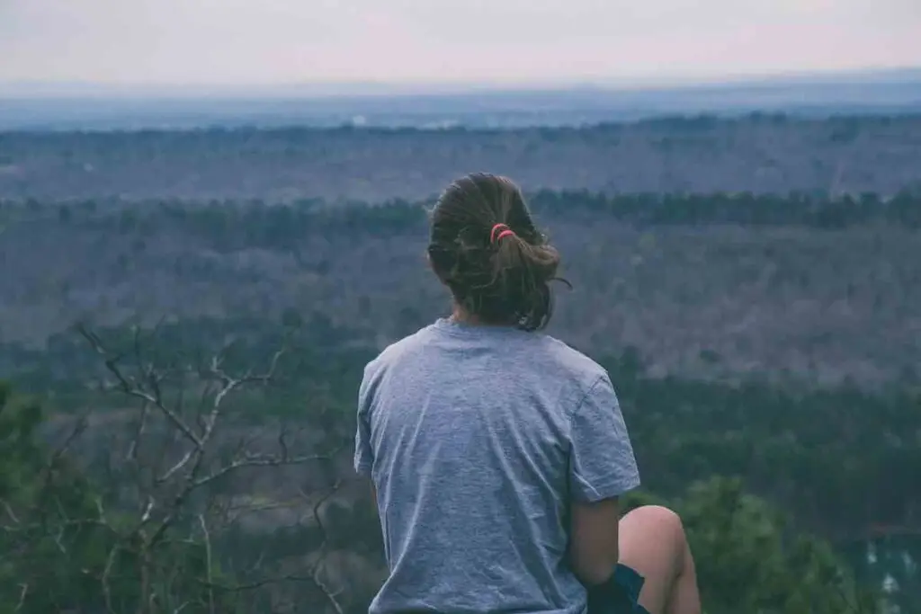 Runner relaxing looking over a field