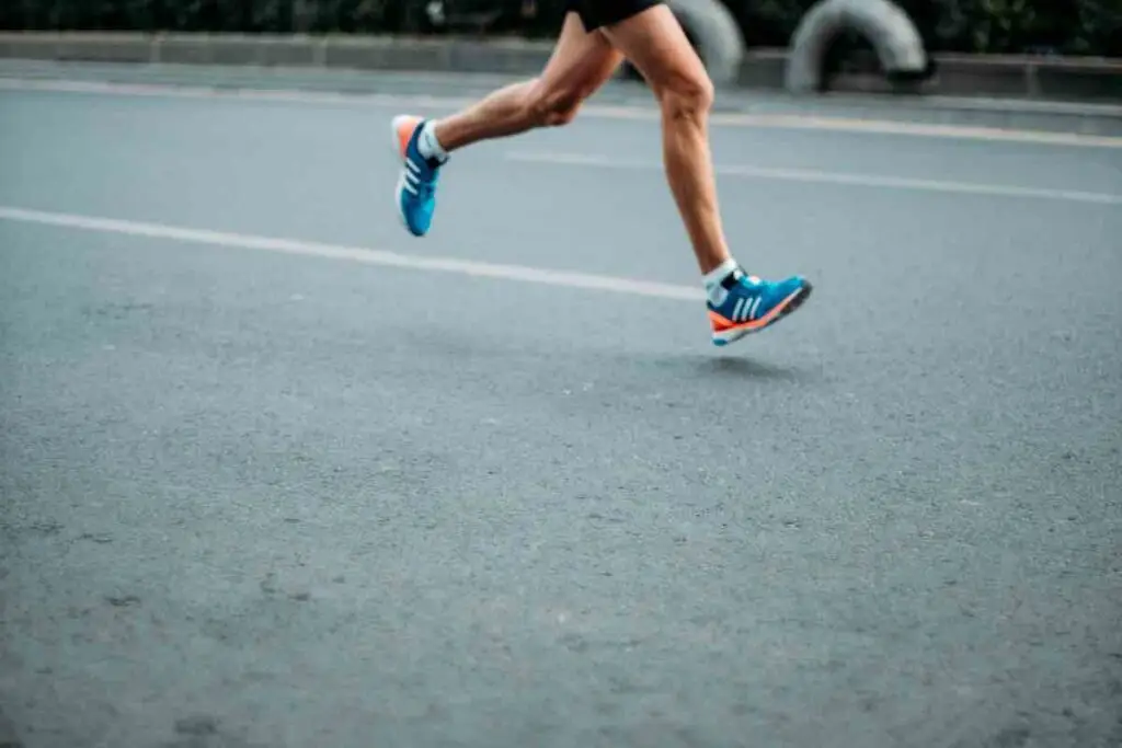 Runners legs on a road