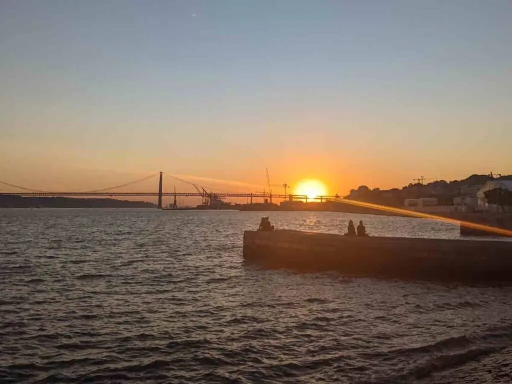 Couples of the docks at sunset in Lisbon